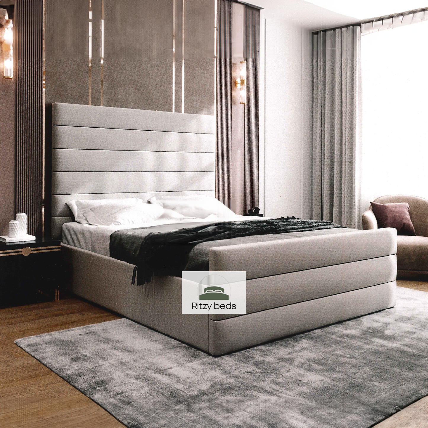 Modern bedroom with a gray bespoke upholstered bed with lines and Ritzy Beds logo.