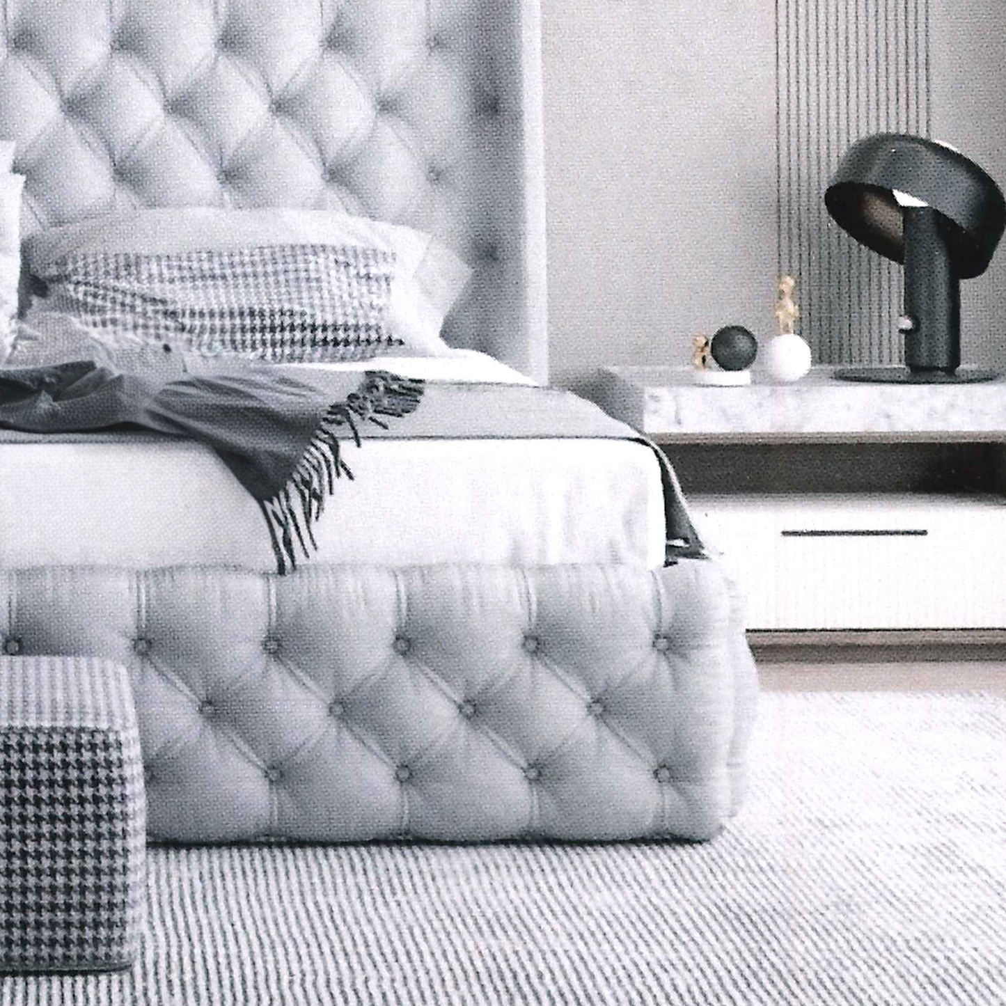 Modern bedroom with tufted buttoned, recessed footboard.