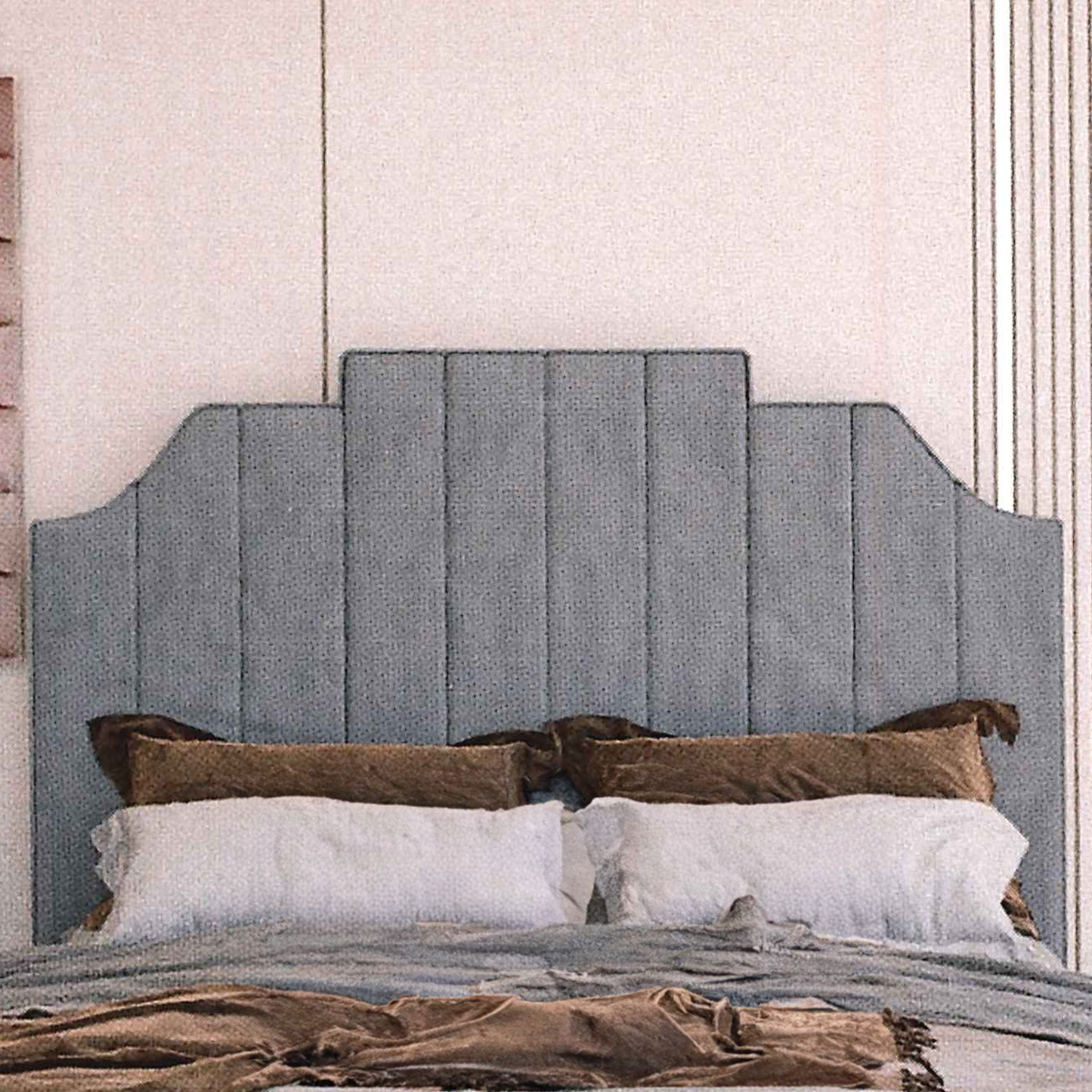 Gray upholstered fluted headboard with pillows on a bed against a neutral wall.