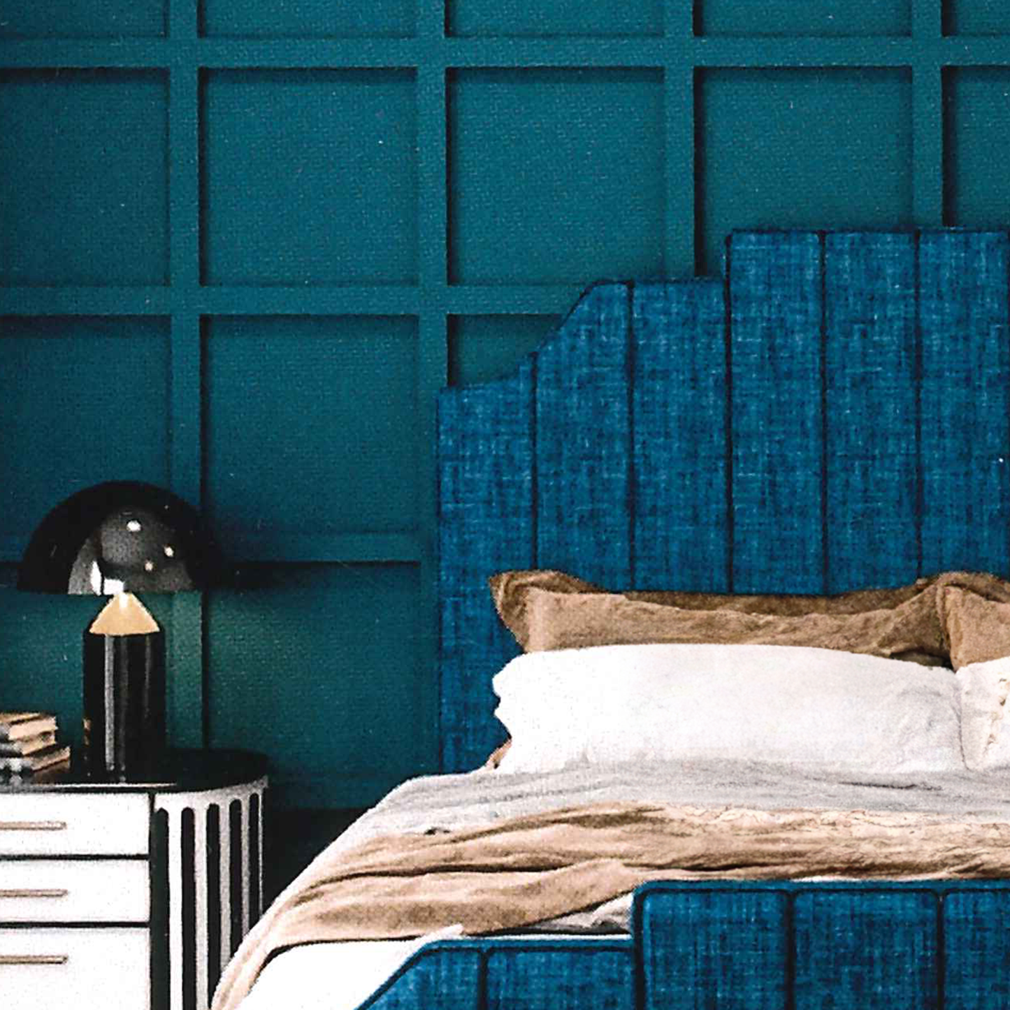 Bedroom with teal textured wall and matching headboard