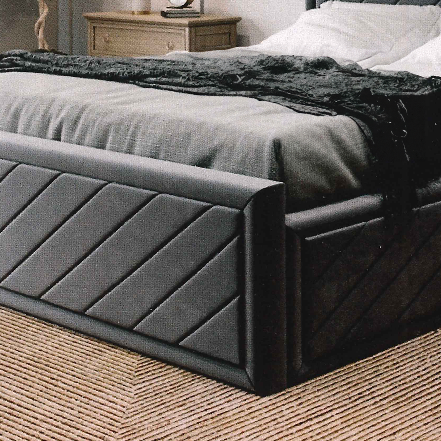 Dark gray upholstered british bed with textured headboard in a bedroom setting