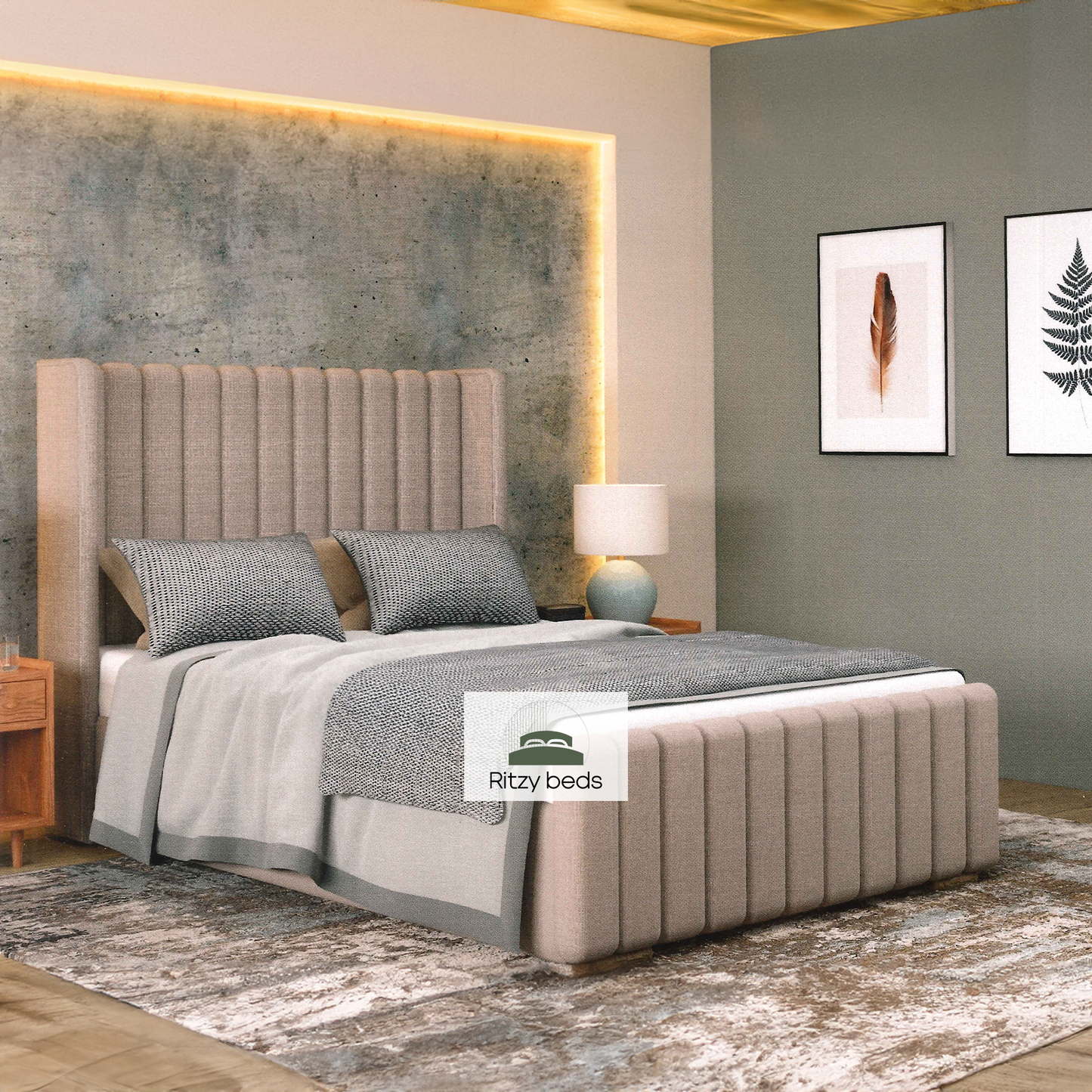 Beige winged upholstered bed with gray bedding in a modern bedroom setting, featuring the Ritzy Beds logo.