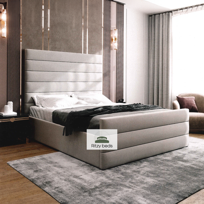 Modern bedroom with a gray bespoke upholstered bed  with lines and Ritzy Beds logo.