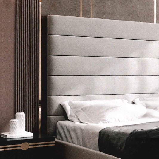 Gray upholstered headboard in a bedroom setting.