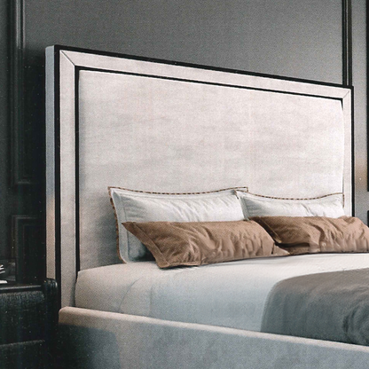 Gray upholstered headboard with decorative pillows on a bed