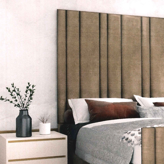 Bedroom with a large upholstered headboard, nightstand, and decorative items.
