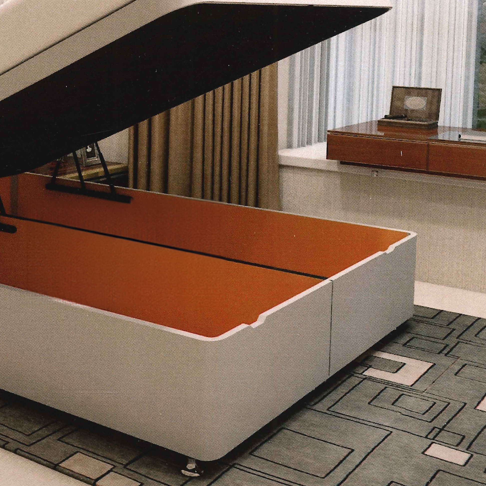 handmade british Bed with discreet storage compartment open in a room with curtains and a desk.