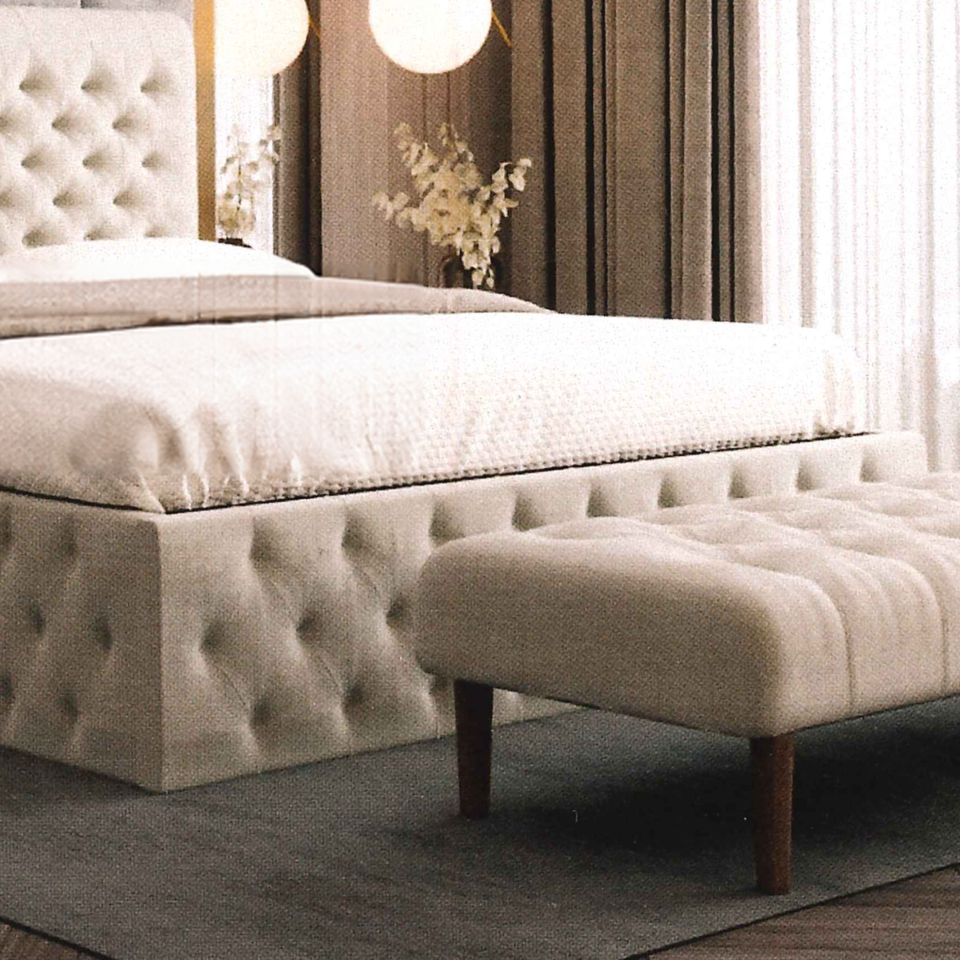 Beige buttoned upholstered handmade bed with tufted design and matching bench in a bedroom setting.