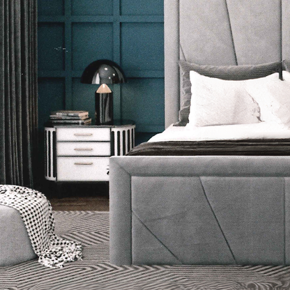 Gray upholstered bed in a bedroom with a teal paneled wall and a nightstand.