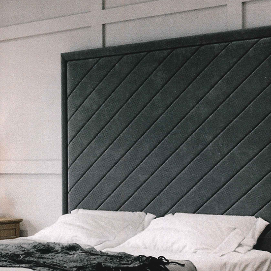 Dark gray geomretic modern luxury headboard against a white wall