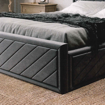 Dark gray upholstered british bed with textured headboard in a bedroom setting