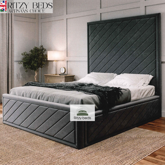 Gray upholstered bed with a modern angular handmade headboard in a bedroom setting, featuring the 'Ritzy Beds' brand.
