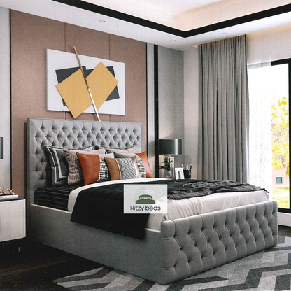 Gray tufted handcrafted bed with decorative pillows in a modern bedroom setting, featuring the 'Ritzy Beds' brand.