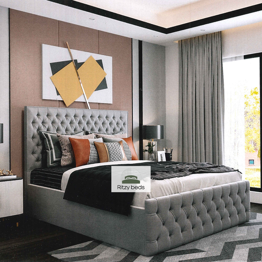 Gray tufted handcrafted bed with decorative pillows in a modern bedroom setting, featuring the 'Ritzy Beds' brand.