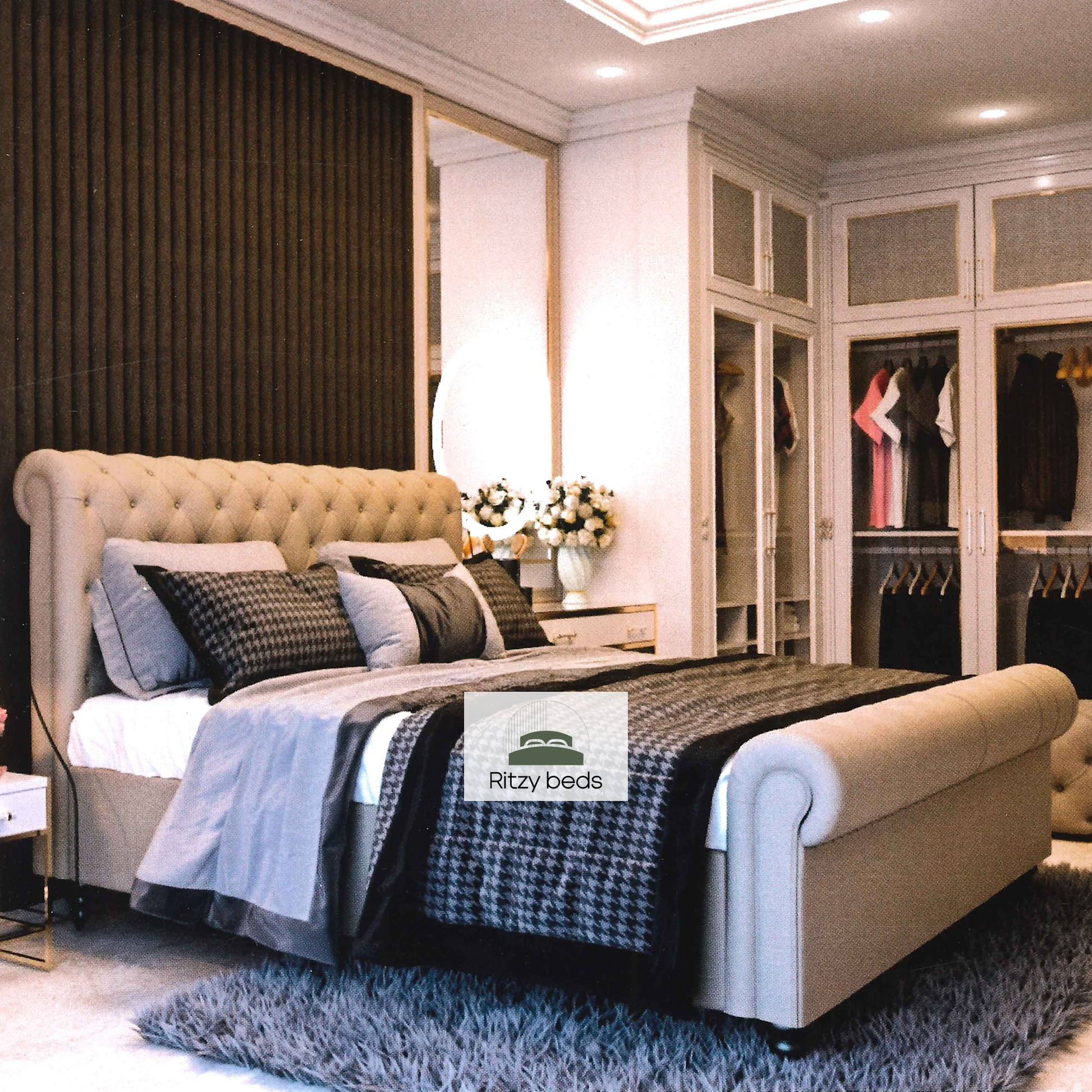 Luxury bedroom with a tufted scroll handmade bed and 'Ritzy Beds' logo.
