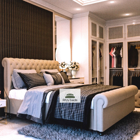 Luxury bedroom with a tufted scroll handmade bed and 'Ritzy Beds' logo.