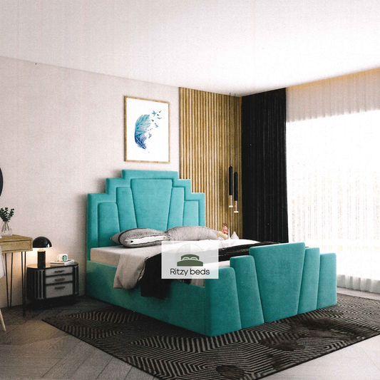 Teal fluted geometric upholstered luxury bed in a modern bedroom with 'Ritzy Beds' branding.