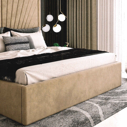 Beige upholstered bed in a modern bedroom setting with decorative pillows and a rug.