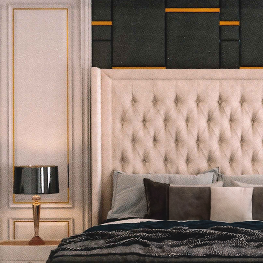Luxury bedroom with tufted headboard, decorative pillows, and wall art.