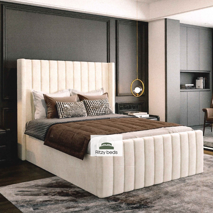 Winged lined luxury upholstered bespoke bed with Ritzy Beds logo.