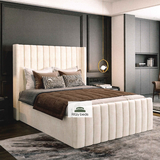 Winged lined luxury upholstered bespoke bed with Ritzy Beds logo.