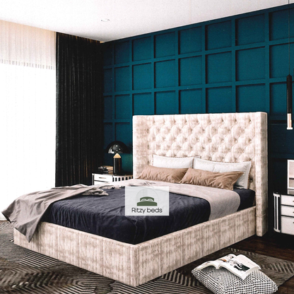 Bedroom with a tufted winged bed and decorative wall, featuring the Ritzy Beds logo.